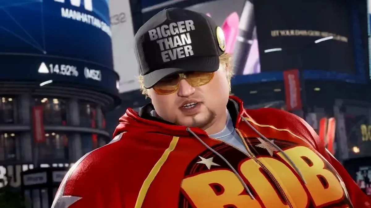 Bob in Tekken 8 wearing a red 'BOB' hoodie and a 'Bigger Than Ever' cap with yellow sunglasses, Manhattan skyline behind him